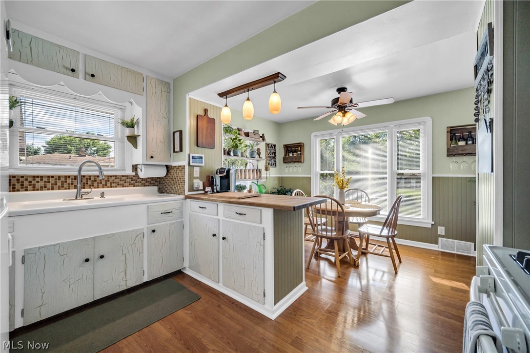 7797 York Road Cleveland, OH 44130 - Photo 5 of 23 Kitchen with ceiling fan, decorative light fixtures, hardwood / wood-style flooring, and backsplash
