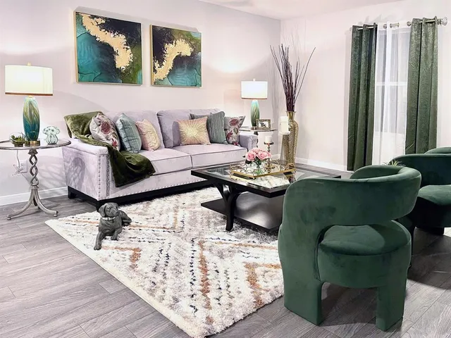 a living room with furniture and wooden floor