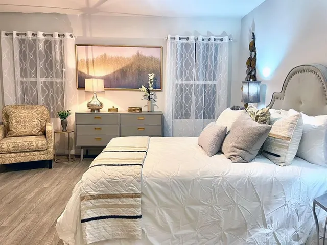 a bedroom with a large bed and a couch