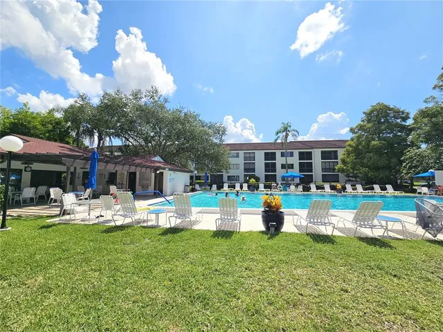 a front view of a house with garden and sitting area