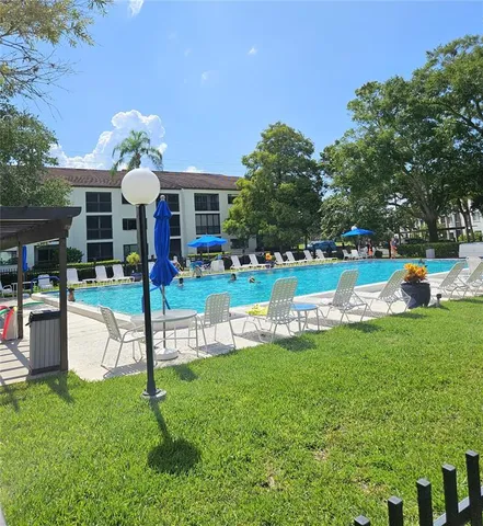 a view of a house with a backyard porch and sitting area