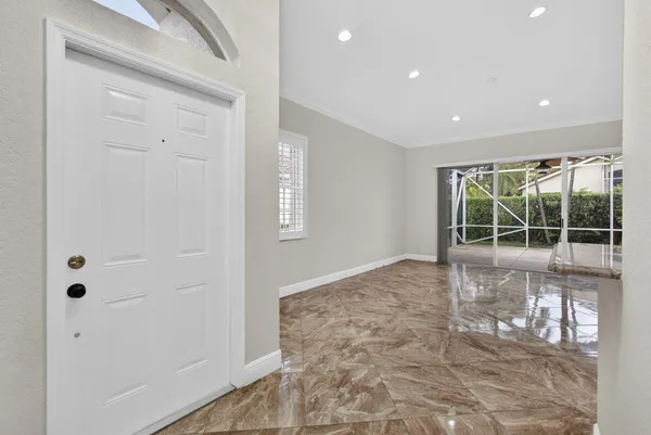 a view of a hallway with wooden floor and closet