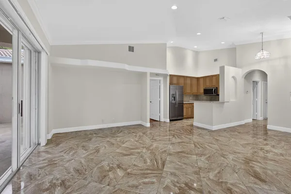 a kitchen with granite countertop a sink stove and microwave