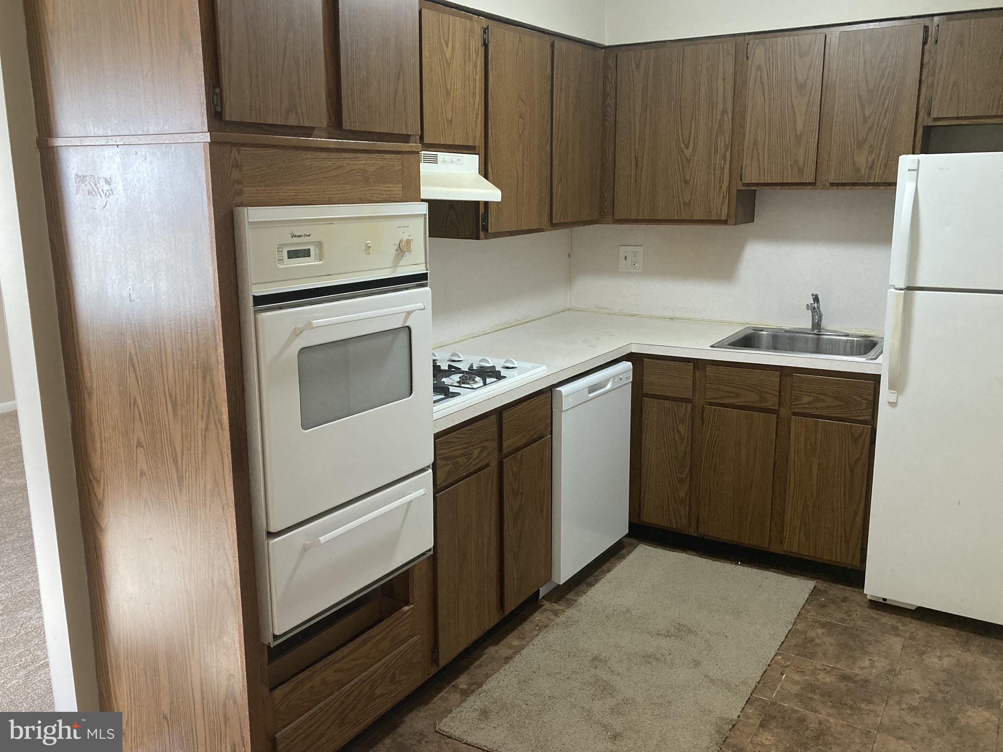 1600 Church Road, Unit A300 Wyncote, PA 19095 - Photo 7 of 16 Cozy kitchen with warm wood tones.