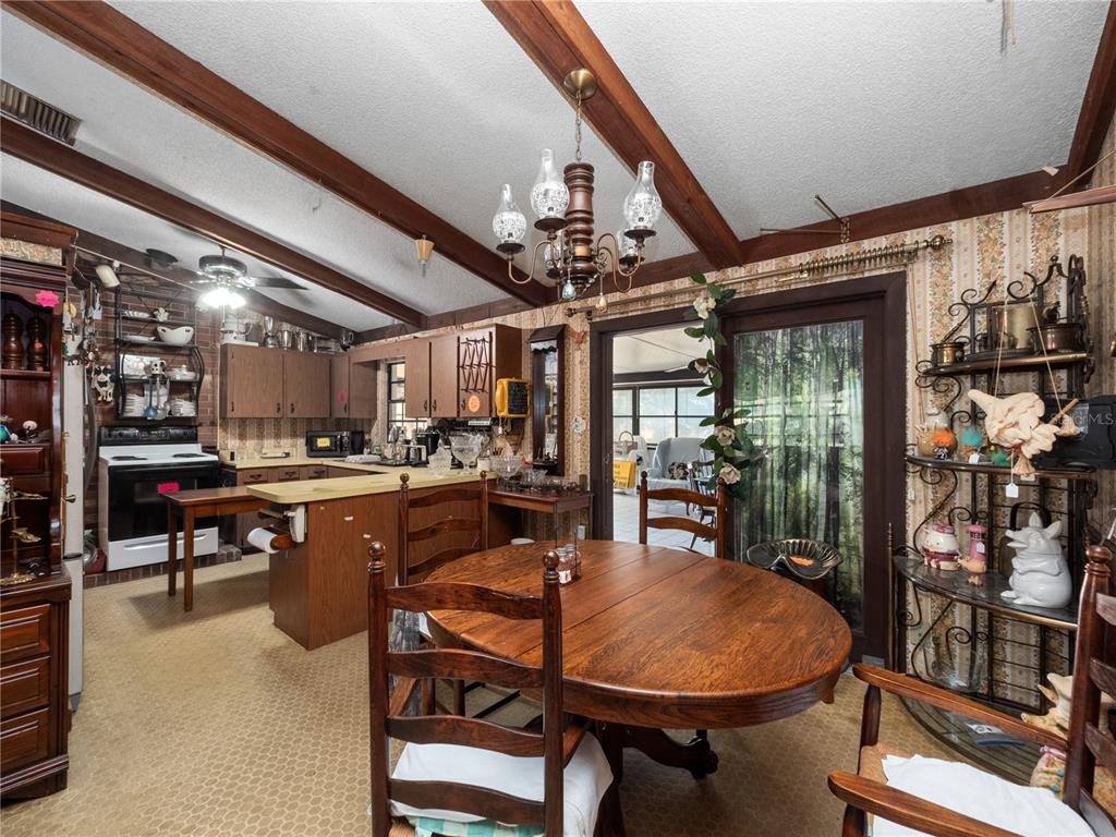 6604 Mt Plymouth Road Apopka, FL 32712 - Photo 11 of 31 a dining room with lots of wooden furniture and a chandelier