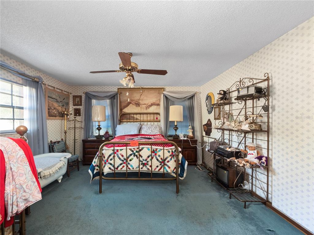 6604 Mt Plymouth Road Apopka, FL 32712 - Photo 17 of 31 a bedroom with a bed and a couch