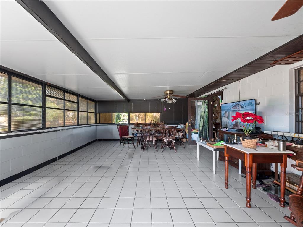 6604 Mt Plymouth Road Apopka, FL 32712 - Photo 19 of 31 a dining room with furniture and a potted plant