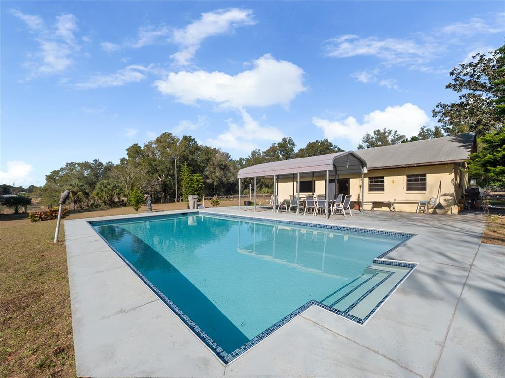 6604 Mt Plymouth Road Apopka, FL 32712 - Photo 20 of 31 a view of a patio with swimming pool and furniture