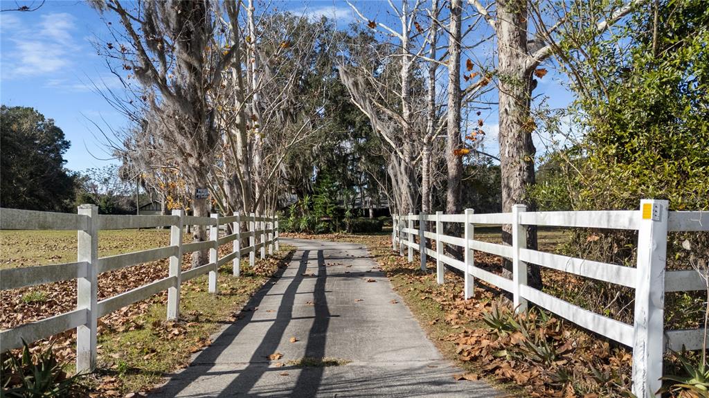 6604 Mt Plymouth Road Apopka, FL 32712 - Photo 2 of 31 a view of a balcony with wooden floor and fence
