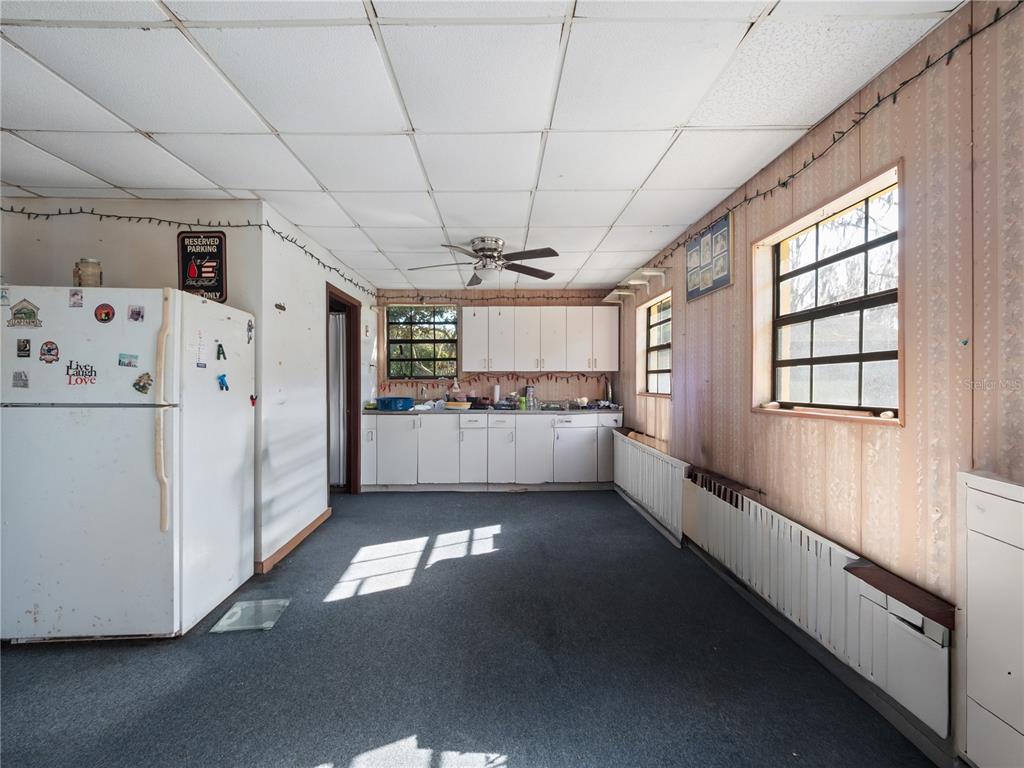 6604 Mt Plymouth Road Apopka, FL 32712 - Photo 23 of 31 a kitchen with stainless steel appliances granite countertop a refrigerator a sink and white cabinets