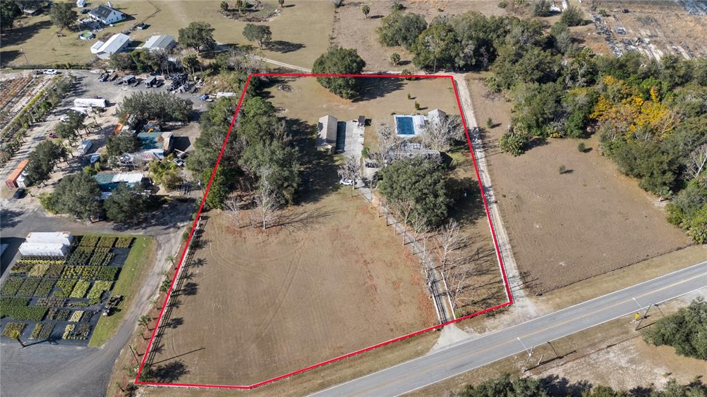 6604 Mt Plymouth Road Apopka, FL 32712 - Photo 3 of 31 an aerial view of residential houses with outdoor space