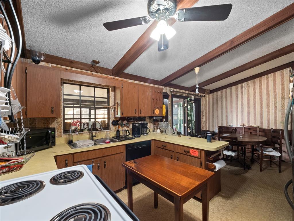 6604 Mt Plymouth Road Apopka, FL 32712 - Photo 9 of 31 a kitchen with a table chairs and a stove