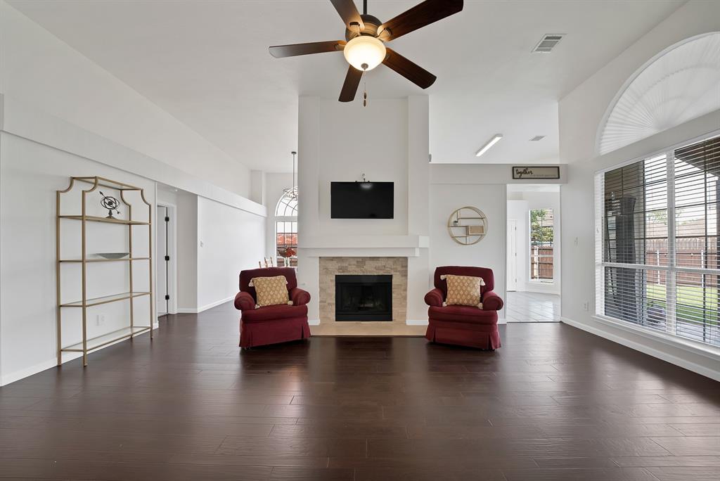 5418 Highgate Lane Rowlett, TX 75088 - Photo 11 of 36 a living room with furniture a fireplace and a flat screen tv