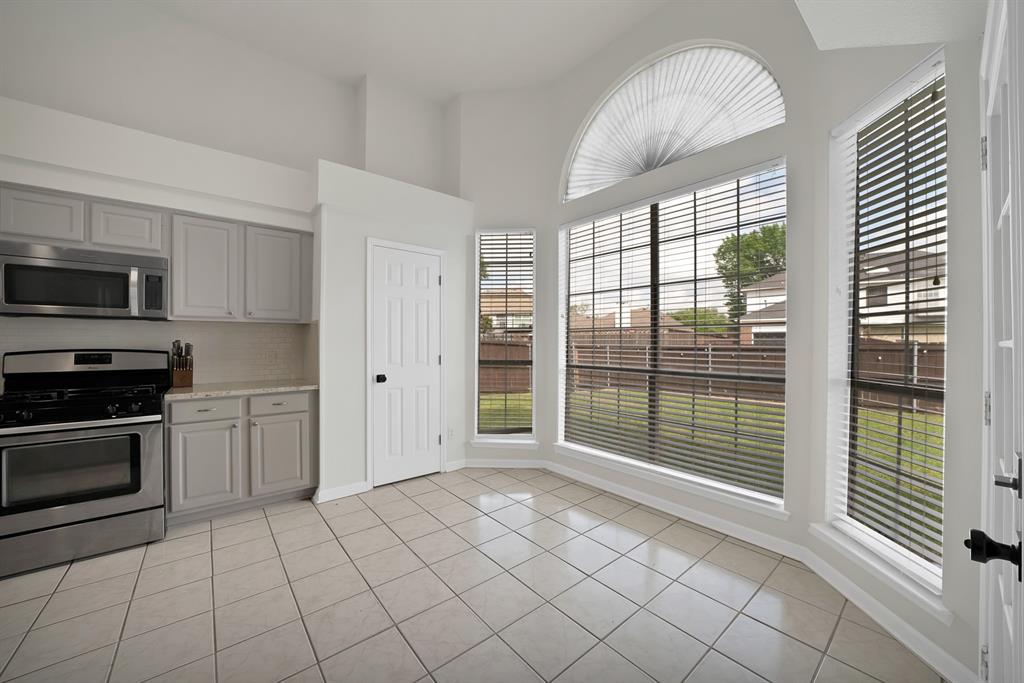 5418 Highgate Lane Rowlett, TX 75088 - Photo 13 of 36 a view of a kitchen with a sink dishwasher and a refrigerator