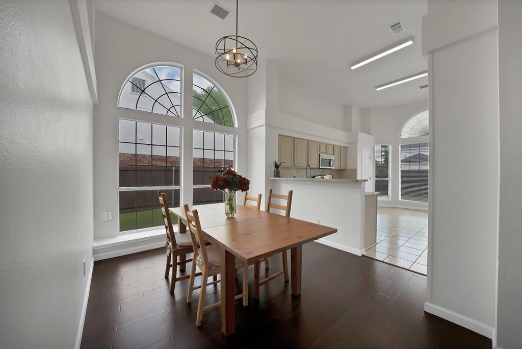 5418 Highgate Lane Rowlett, TX 75088 - Photo 17 of 36 a view of a dining room with furniture window and wooden floor