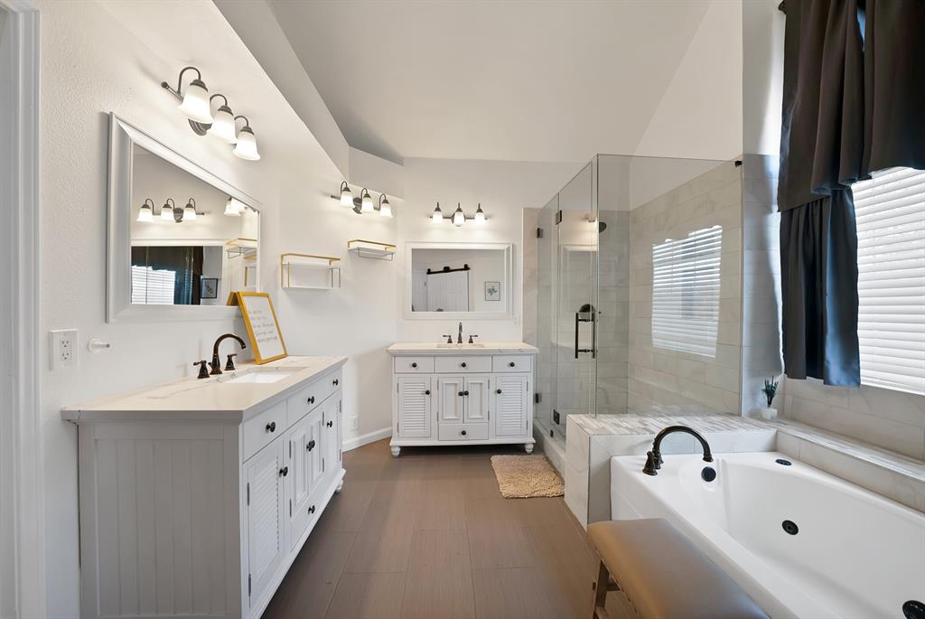 5418 Highgate Lane Rowlett, TX 75088 - Photo 20 of 36 a bathroom with a tub sink double vanity and mirror