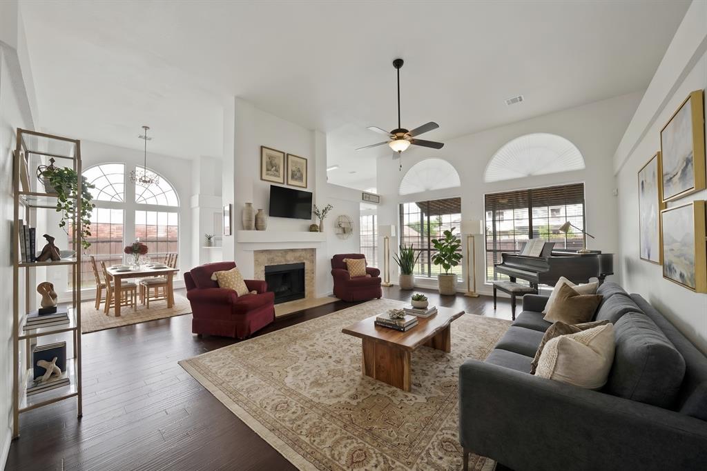 5418 Highgate Lane Rowlett, TX 75088 - Photo 2 of 36 a living room with furniture a fireplace and a flat screen tv