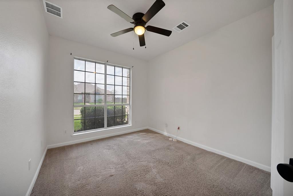 5418 Highgate Lane Rowlett, TX 75088 - Photo 26 of 36 an empty room with a window and a ceiling fan