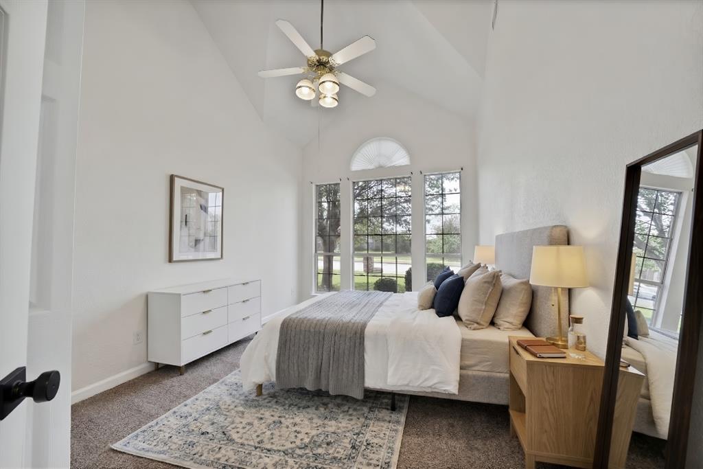 5418 Highgate Lane Rowlett, TX 75088 - Photo 3 of 36 a bedroom with a bed and a chandelier