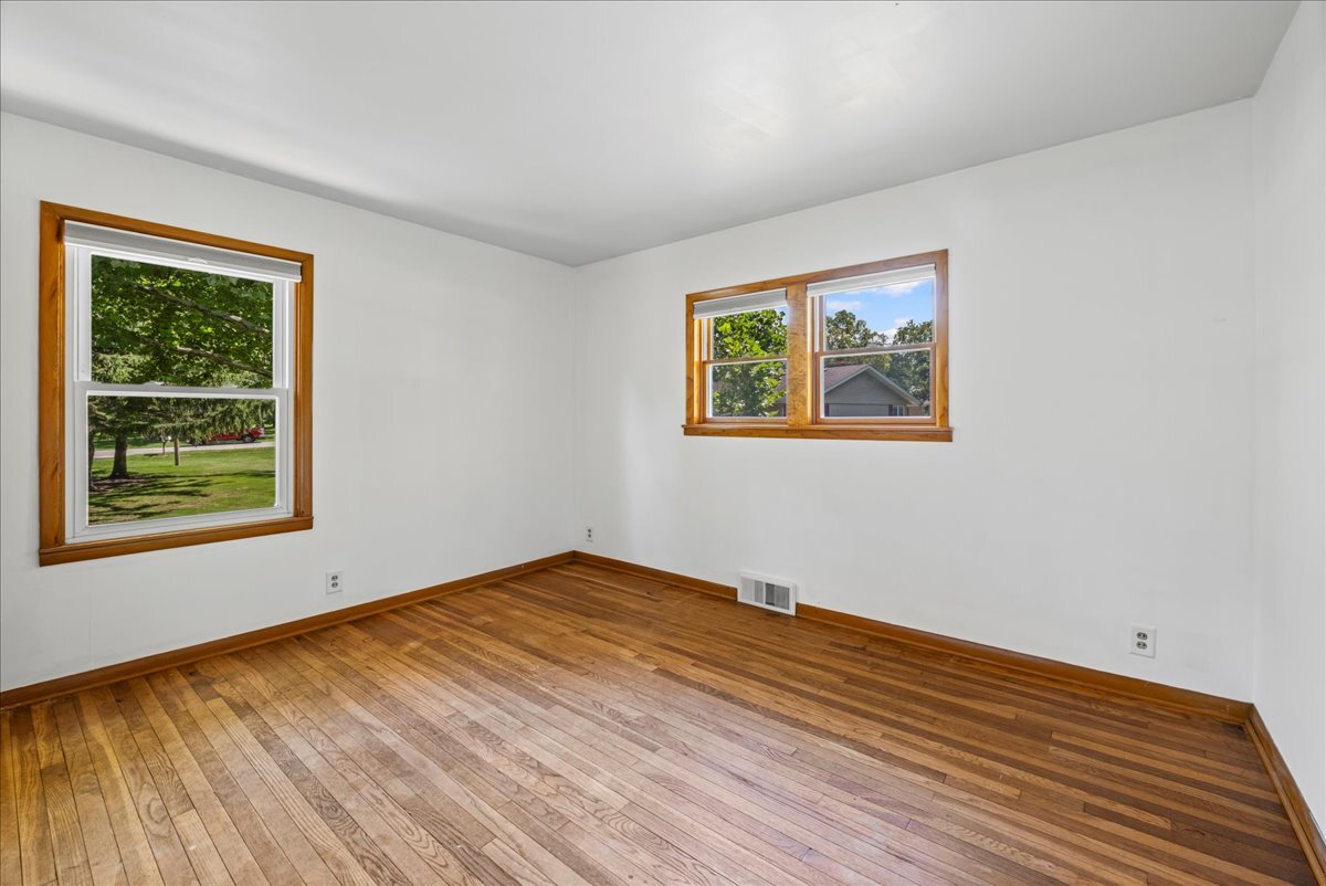 4615 Blue Jay Road Harvard, IL 60033 - Photo 15 of 30 a view of an empty room with window and wooden floor