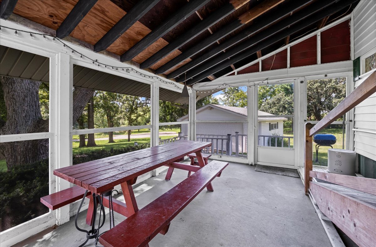 4615 Blue Jay Road Harvard, IL 60033 - Photo 18 of 30 a view of a deck with wooden floor and roof with a small garden