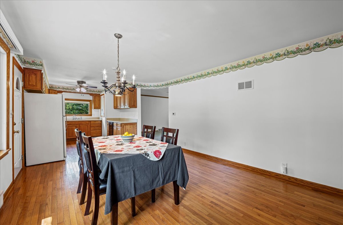 4615 Blue Jay Road Harvard, IL 60033 - Photo 7 of 30 a view of a dining room with furniture window and wooden floor