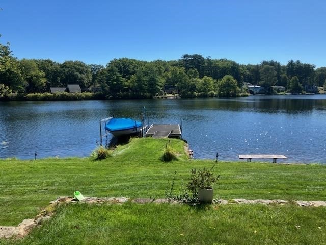 a backyard of a house with lots of green space and lake view