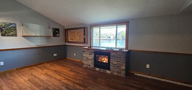a living room with hard wood floors and a fireplace