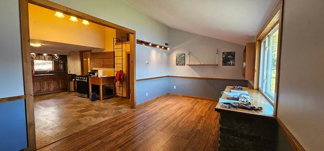 a room with wooden floor and furniture