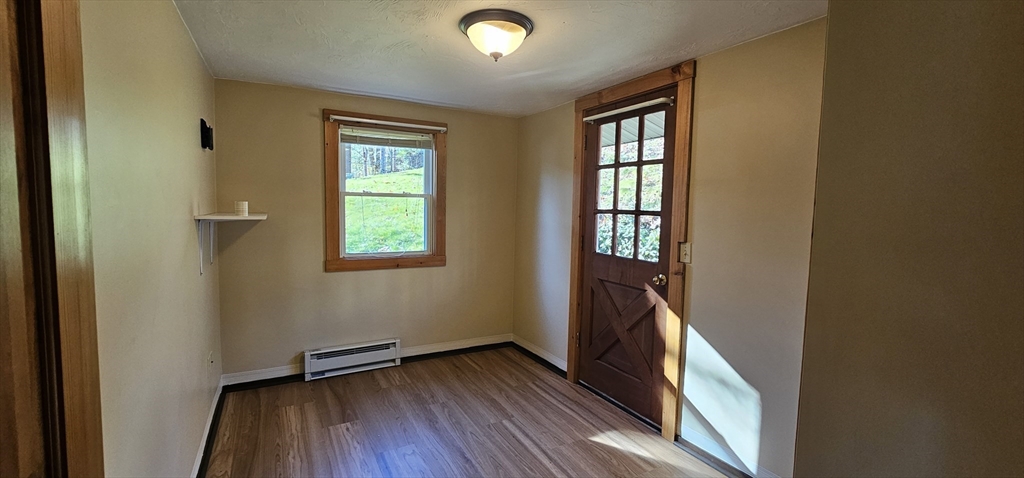 89 Jolicoeur Avenue, Unit 1 Spencer, MA 01562 - Photo 9 of 13 an empty room with wooden floor and windows