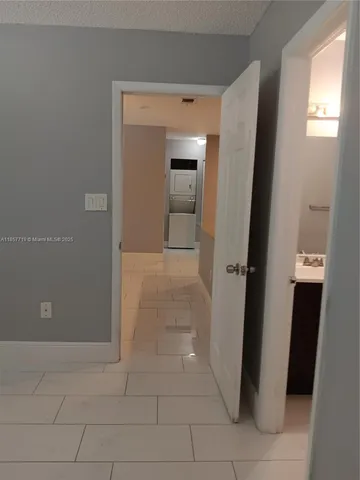 a view of a hallway to rooms