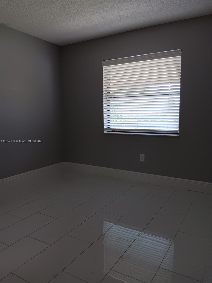 6040 Shaker Wood Circle, Unit 208 Tamarac, FL 33319 - Photo 20 of 25 a room that has a window in it