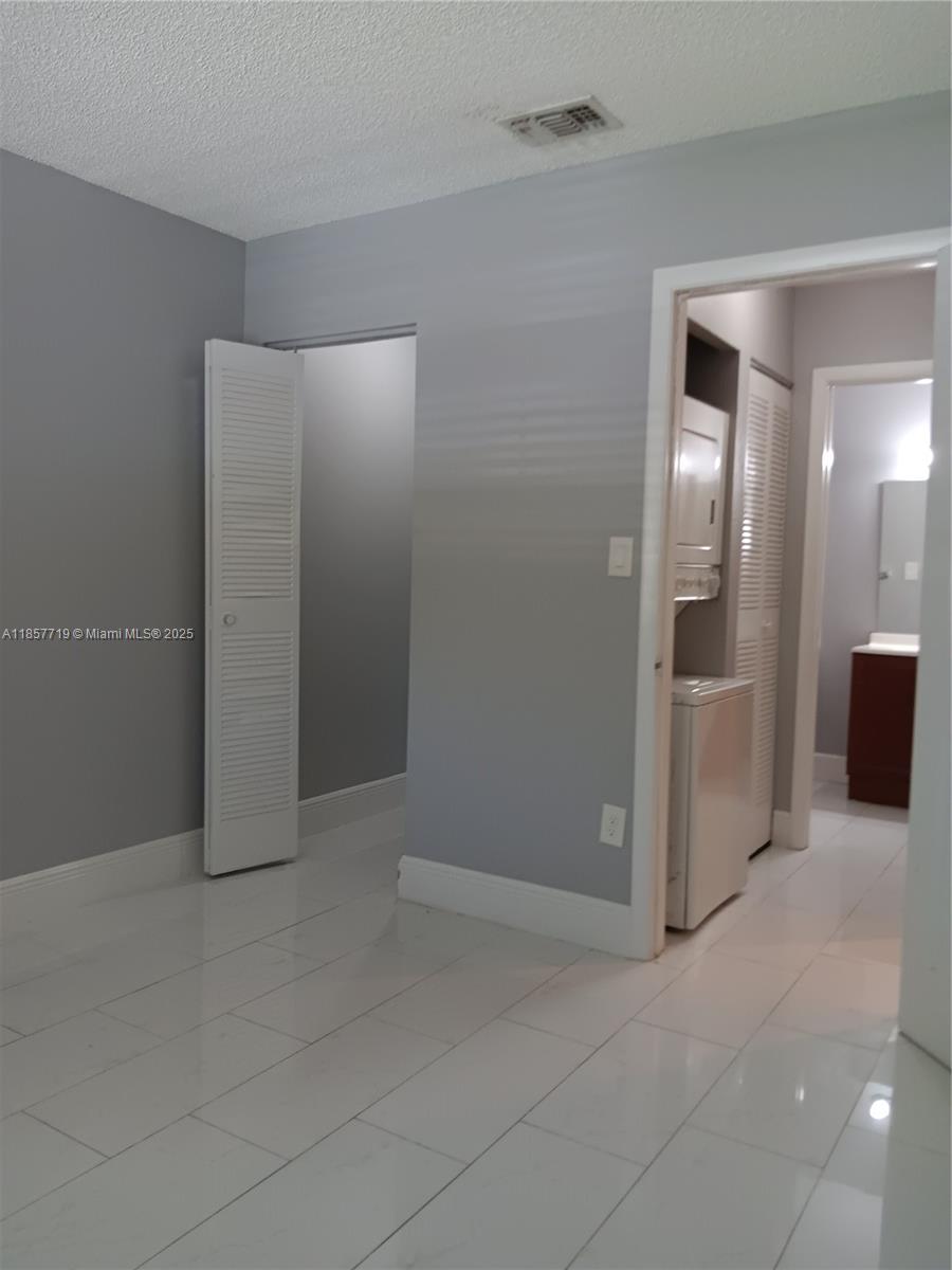 6040 Shaker Wood Circle, Unit 208 Tamarac, FL 33319 - Photo 22 of 25 an empty room with a bathroom