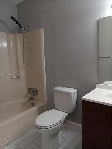 a bathroom with a toilet and shower