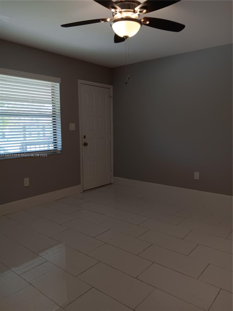 6040 Shaker Wood Circle, Unit 208 Tamarac, FL 33319 - Photo 6 of 25 a view of an empty room with a window