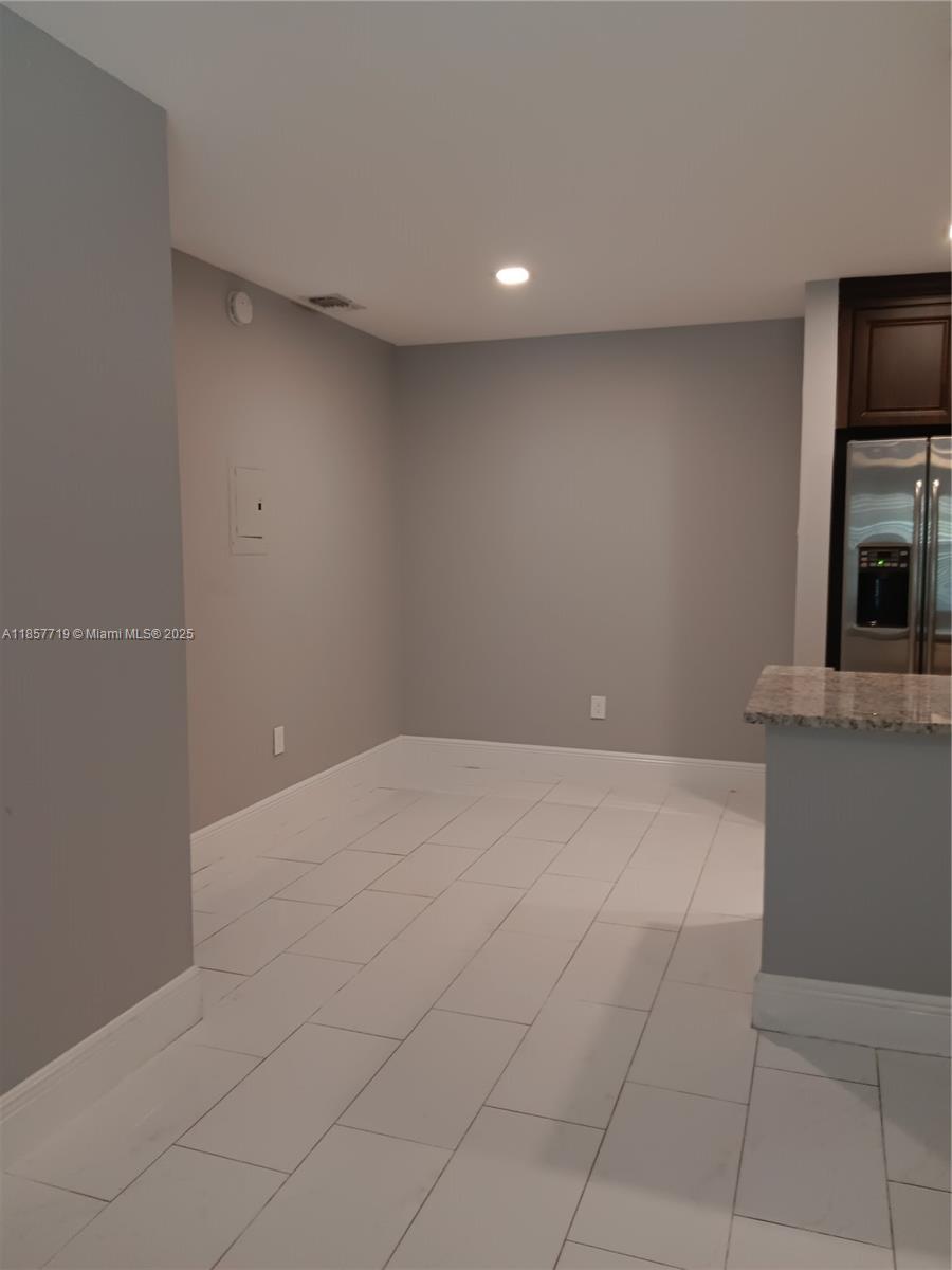 6040 Shaker Wood Circle, Unit 208 Tamarac, FL 33319 - Photo 7 of 25 a view of an empty room with a fireplace and a window