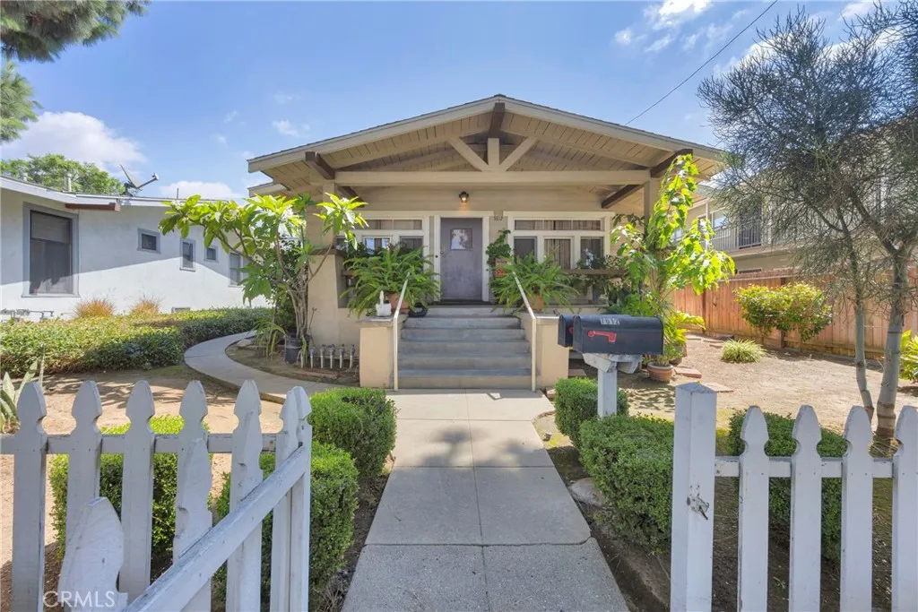 7612 Pickering Avenue Whittier, CA 90602 - Photo 1 of 53 a front view of house with yard and green space