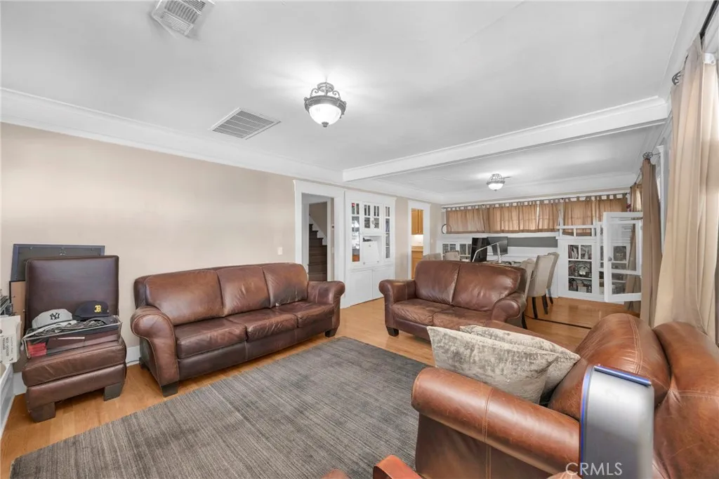 7612 Pickering Avenue Whittier, CA 90602 - Photo 12 of 53 a living room with furniture and a wooden floor