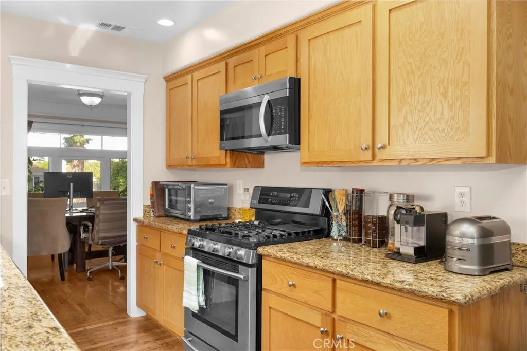 7612 Pickering Avenue Whittier, CA 90602 - Photo 17 of 53 a kitchen with granite countertop a sink a stove and cabinets