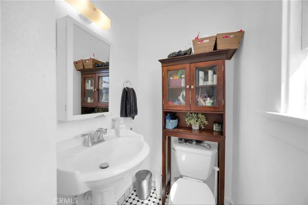 7612 Pickering Avenue Whittier, CA 90602 - Photo 20 of 53 a bathroom with a sink toilet and mirror
