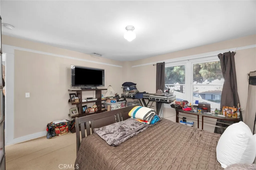 7612 Pickering Avenue Whittier, CA 90602 - Photo 24 of 53 a living room with furniture and a flat screen tv