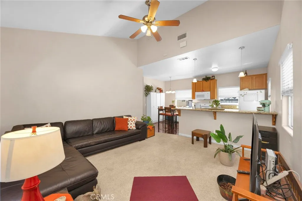7612 Pickering Avenue Whittier, CA 90602 - Photo 33 of 53 a living room with furniture kitchen view and a chandelier