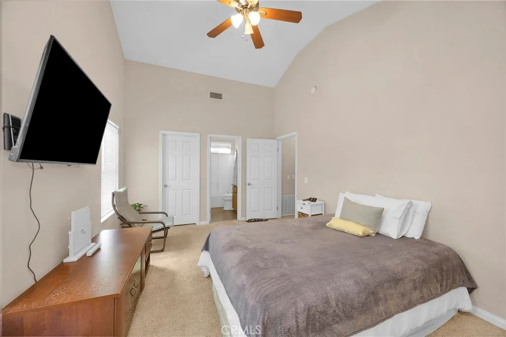 7612 Pickering Avenue Whittier, CA 90602 - Photo 47 of 53 a spacious bedroom with a bed and a flat screen tv