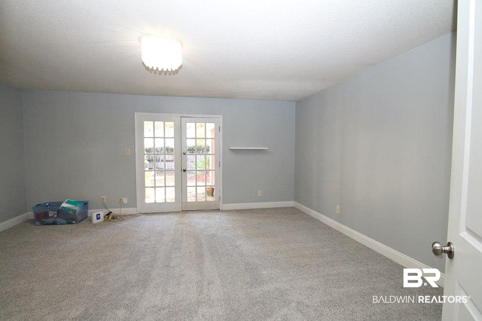 205 Montclair Loop Daphne, AL 36526 - Photo 8 of 19 Spare room with carpet and french doors