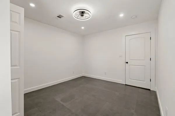 an empty room with a fan