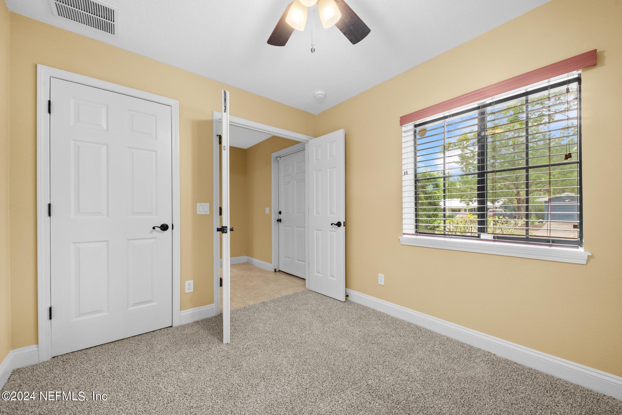 218 Lily Road St. Augustine, FL 32086 - Photo 25 of 28 a view of an empty room with a window