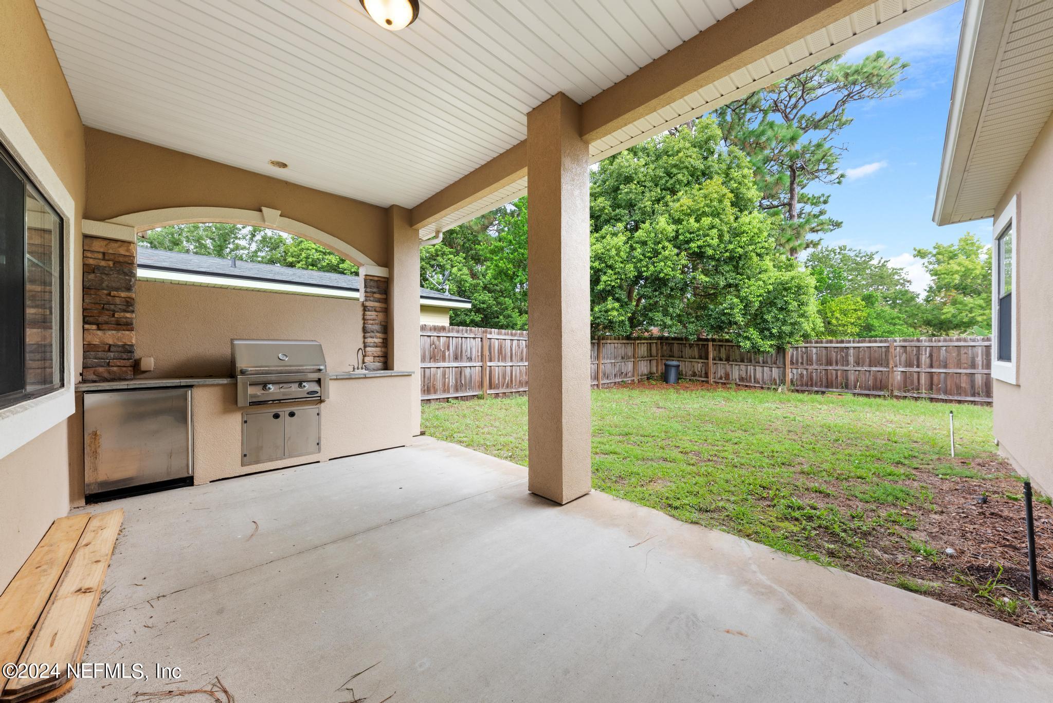 218 Lily Road St. Augustine, FL 32086 - Photo 27 of 28 a view of a backyard with porch and garden