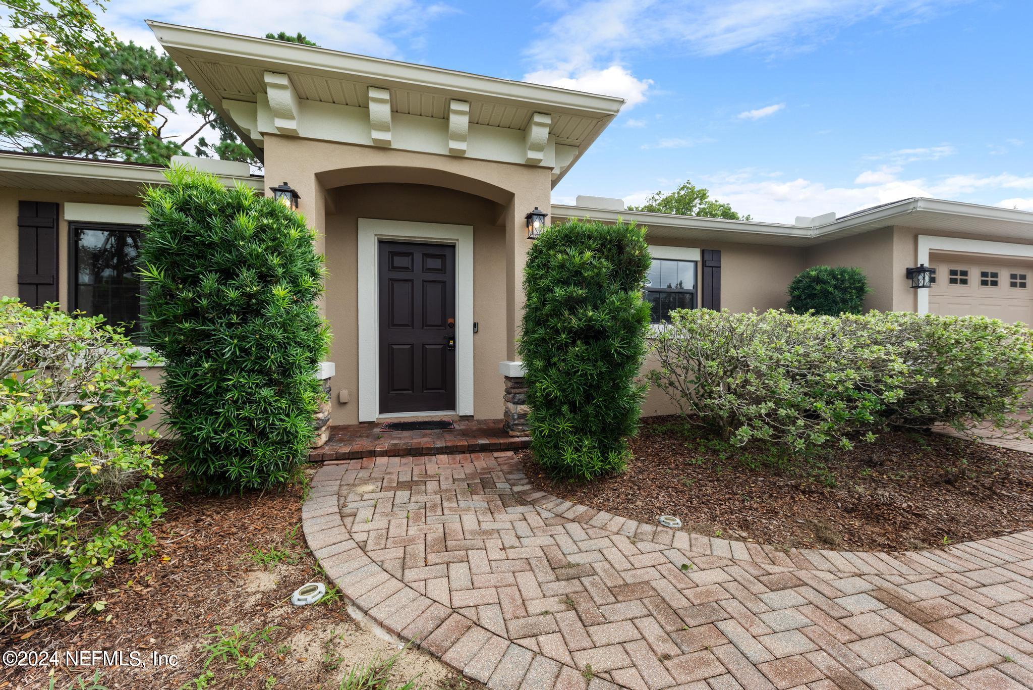 218 Lily Road St. Augustine, FL 32086 - Photo 5 of 28 a front view of a house with garden