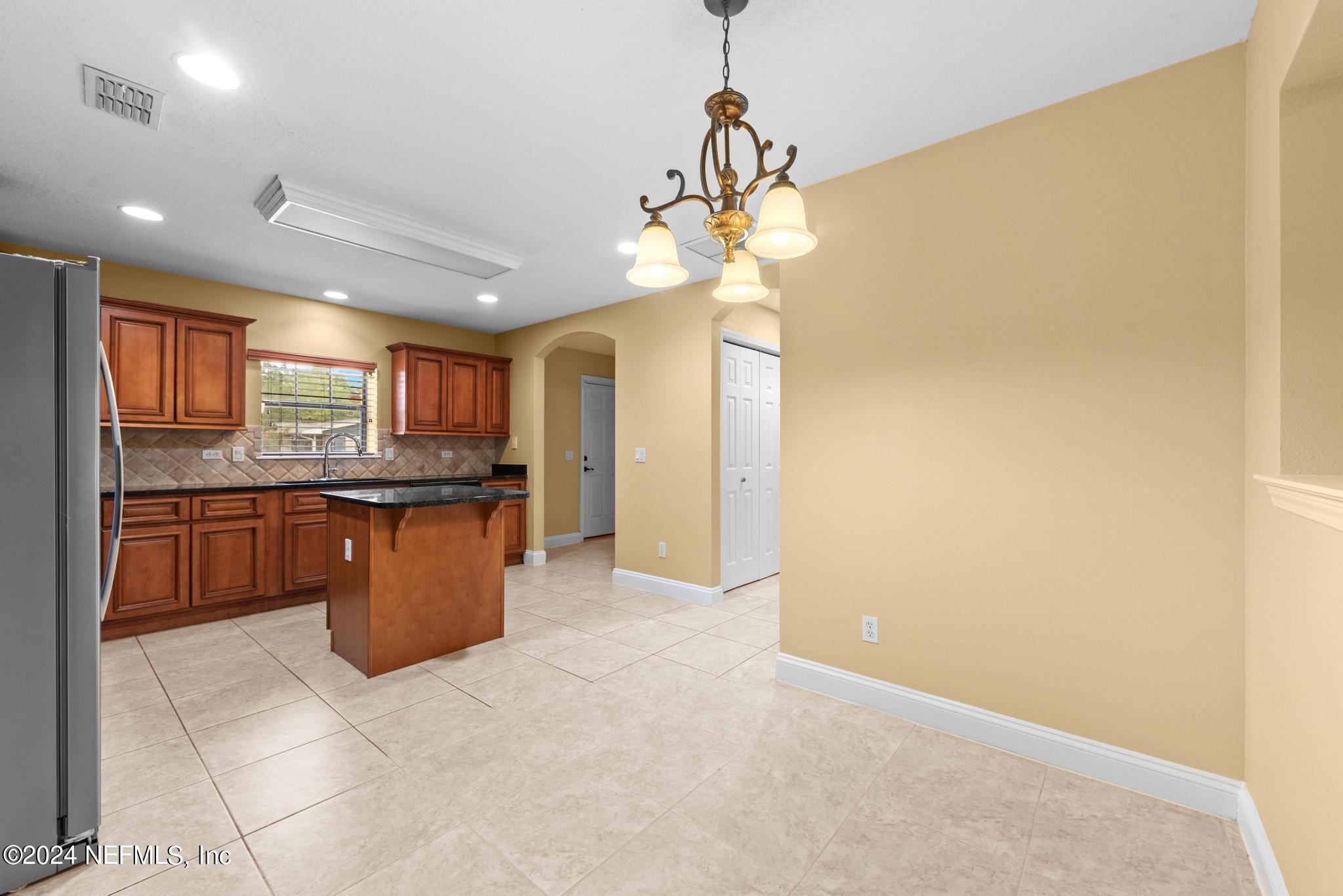 218 Lily Road St. Augustine, FL 32086 - Photo 8 of 28 a large kitchen with a decorative lights
