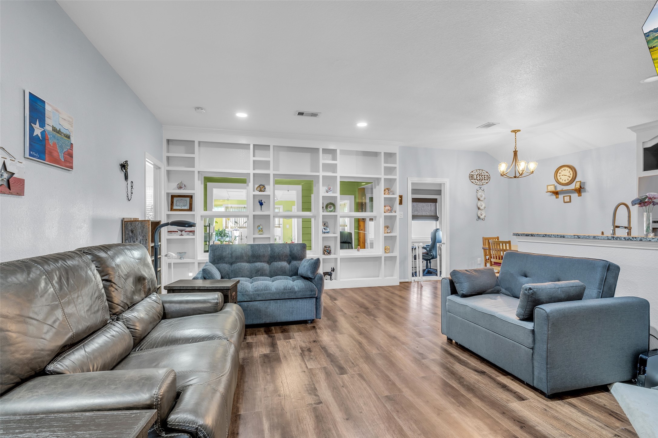 242 Sunset Path North Conroe, TX 77316 - Photo 11 of 37 This living space can accommodate LARGE scale furniture. Classic layout with custom features like the cast stone fireplace, open bookcase, and views through the flex space and new sunroom! 242 SUNSET PATH N - Request your tour today!